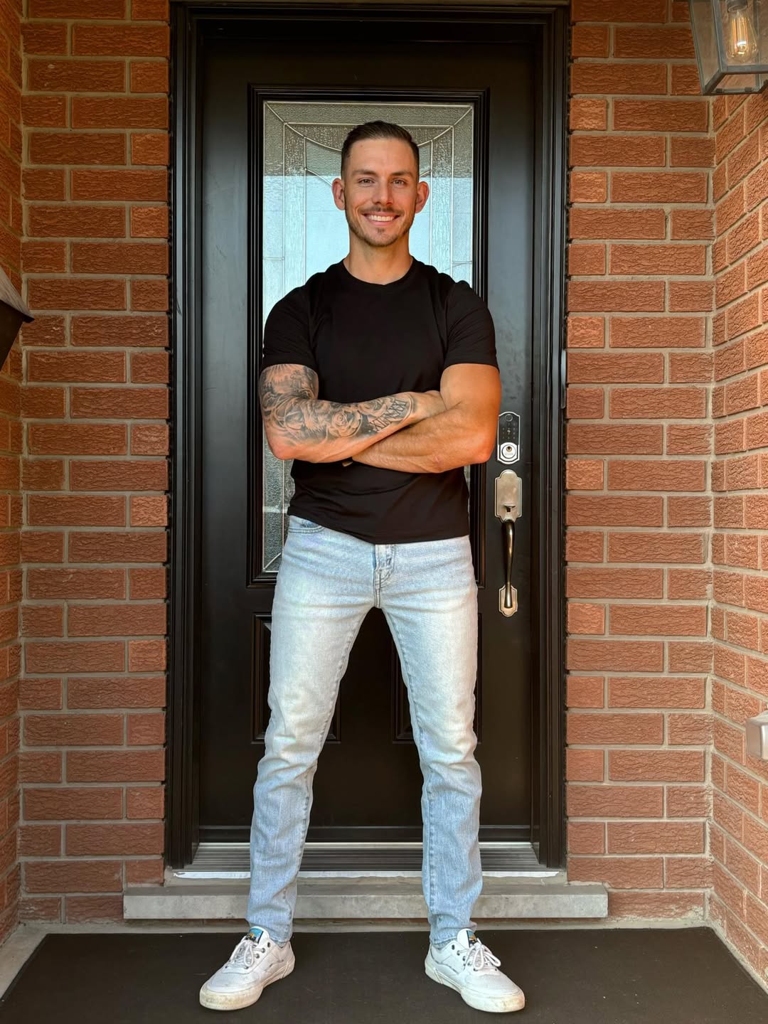 Jim, owner of Rivers Interior Finishing, standing at a front door
